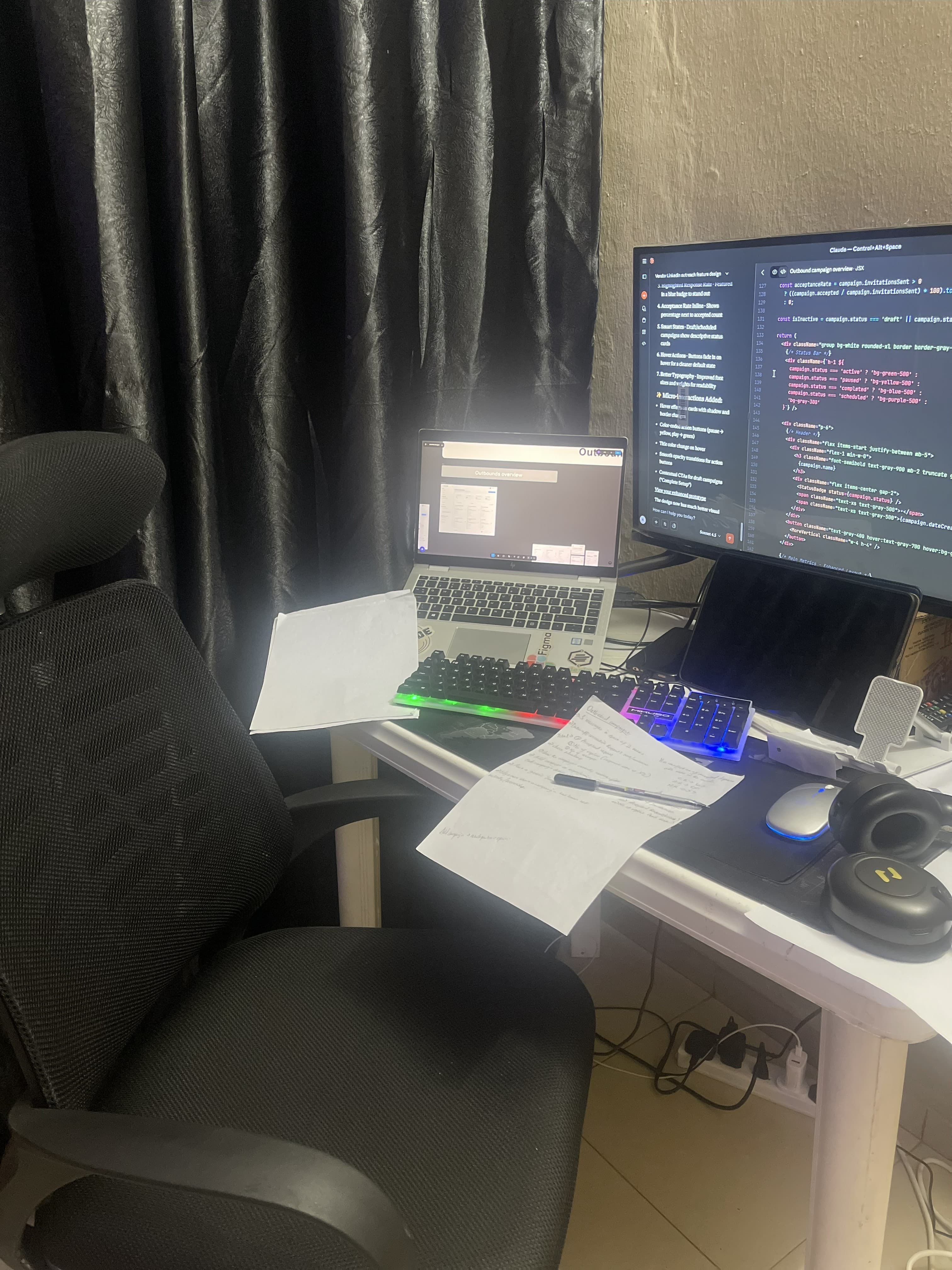 Home desk with monitor, laptop, and notes