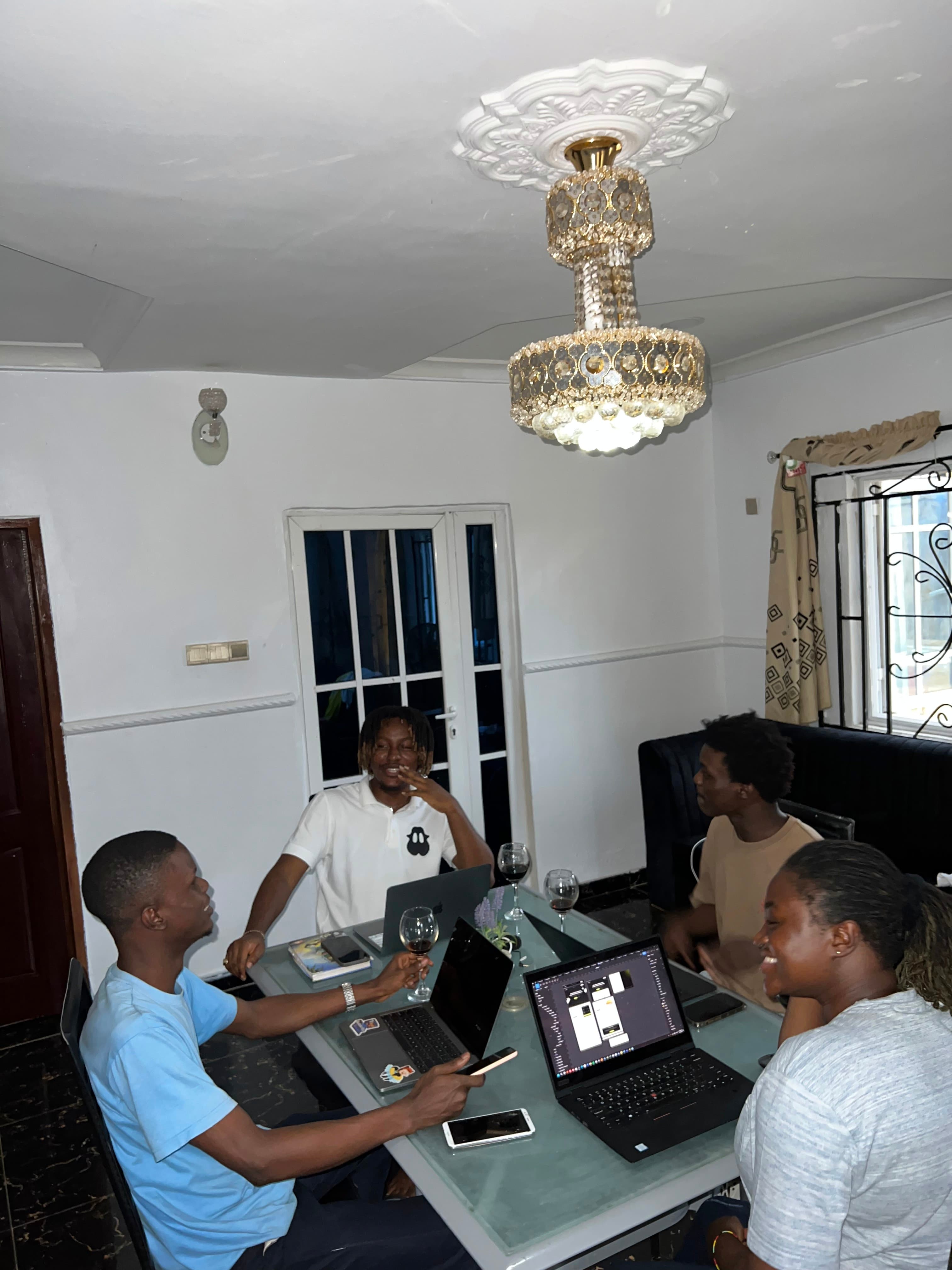 Working session with the team around a dining table, laptops open