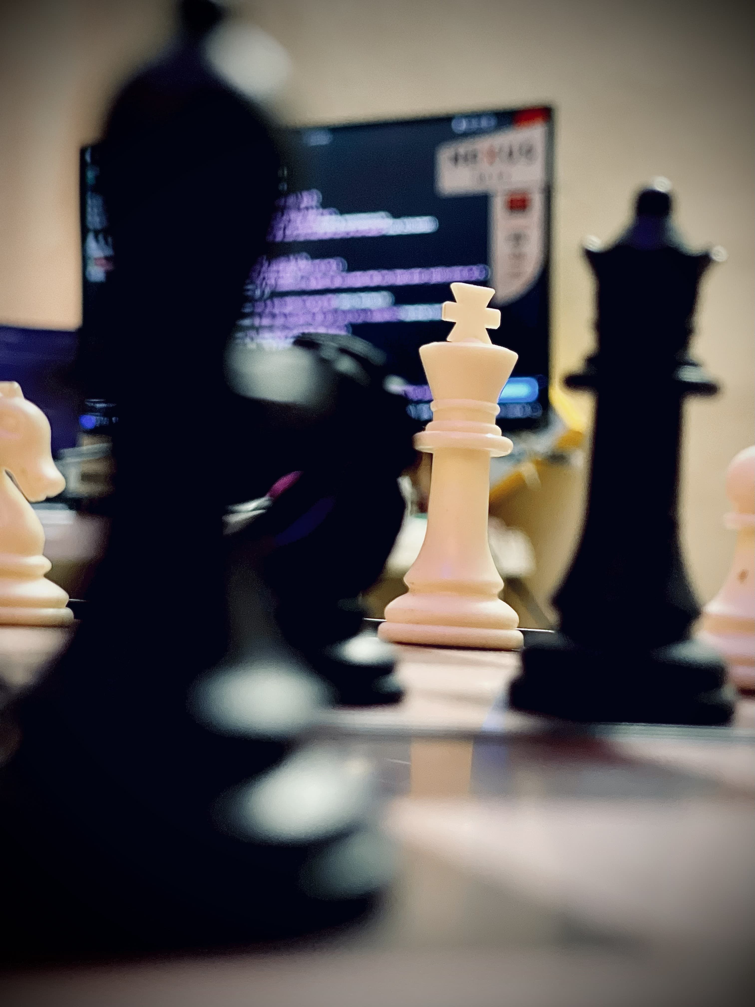 Chess king piece in focus, terminal glowing behind